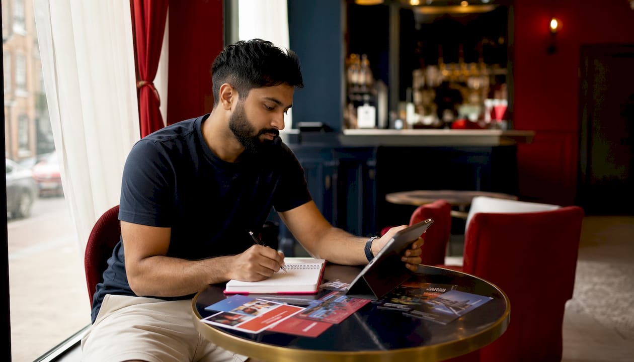 Man planning Galway stag activities at home desk