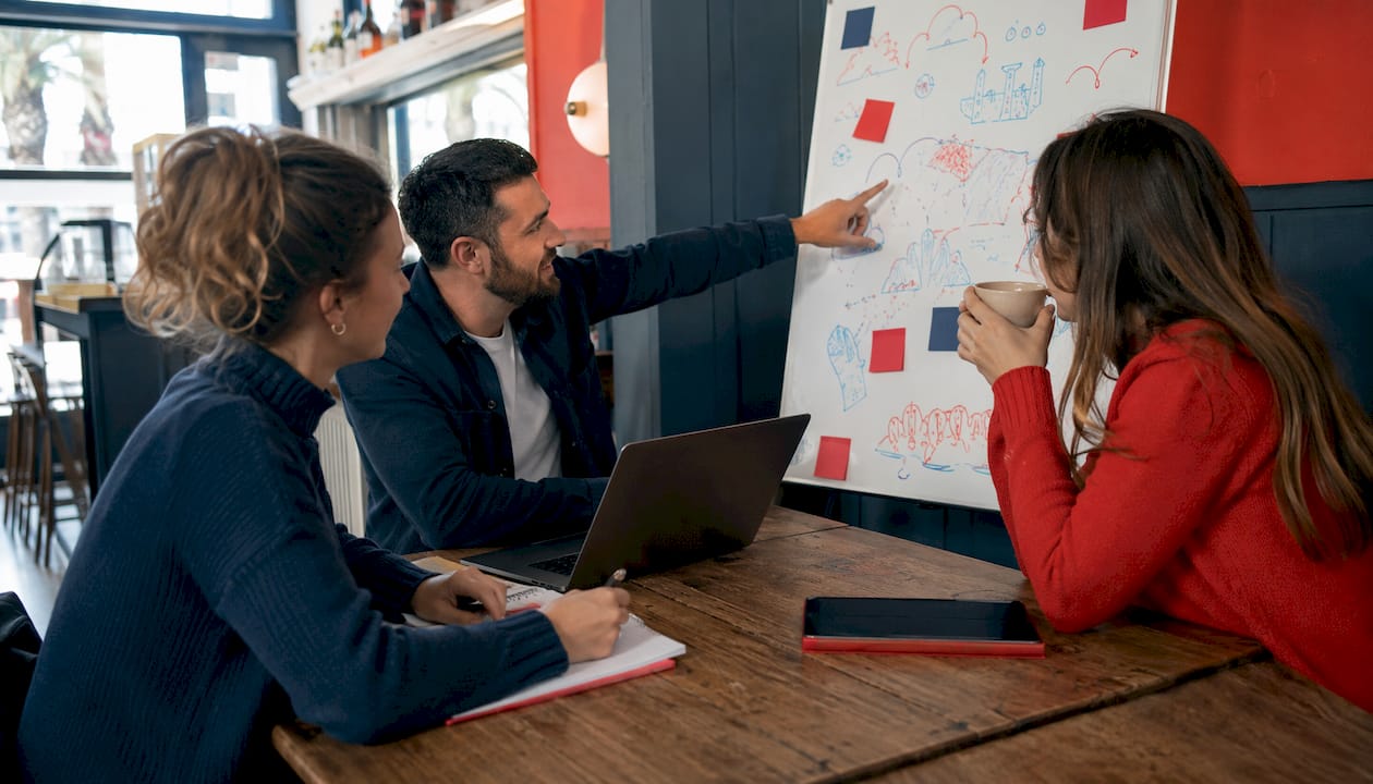 Small team collaborating on event planning in office