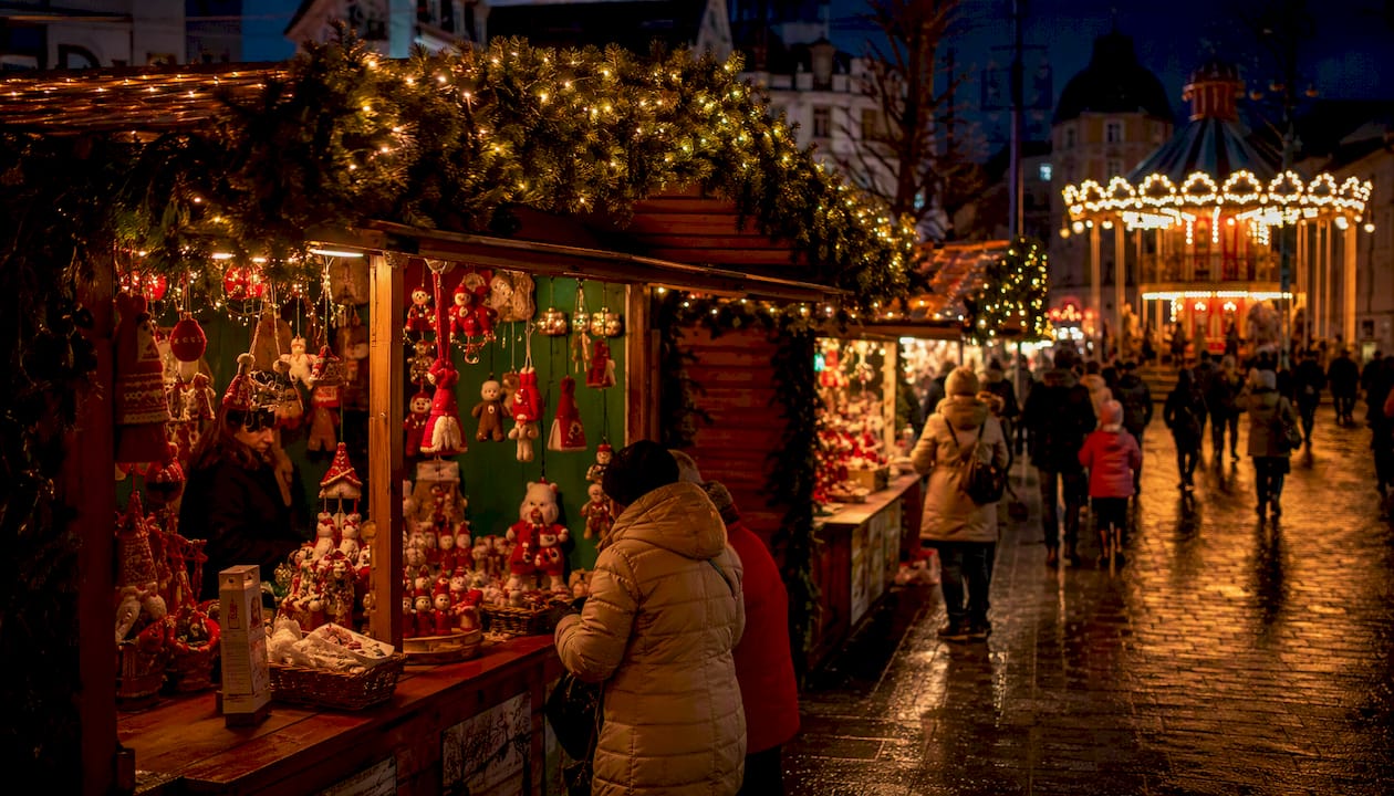 Festively lit Galway Christmas Market chalets at dusk