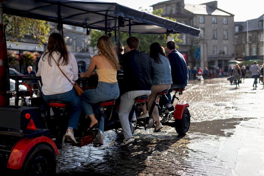 Covered pedal-powered party bike on Galway street
