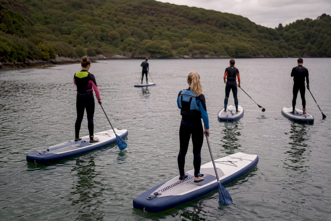 People paddleboarding on calm waters at Rusheen Bay