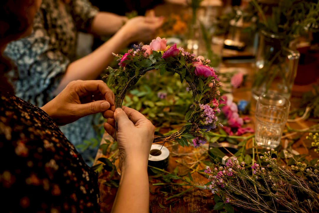 Hands making flower crown workshop