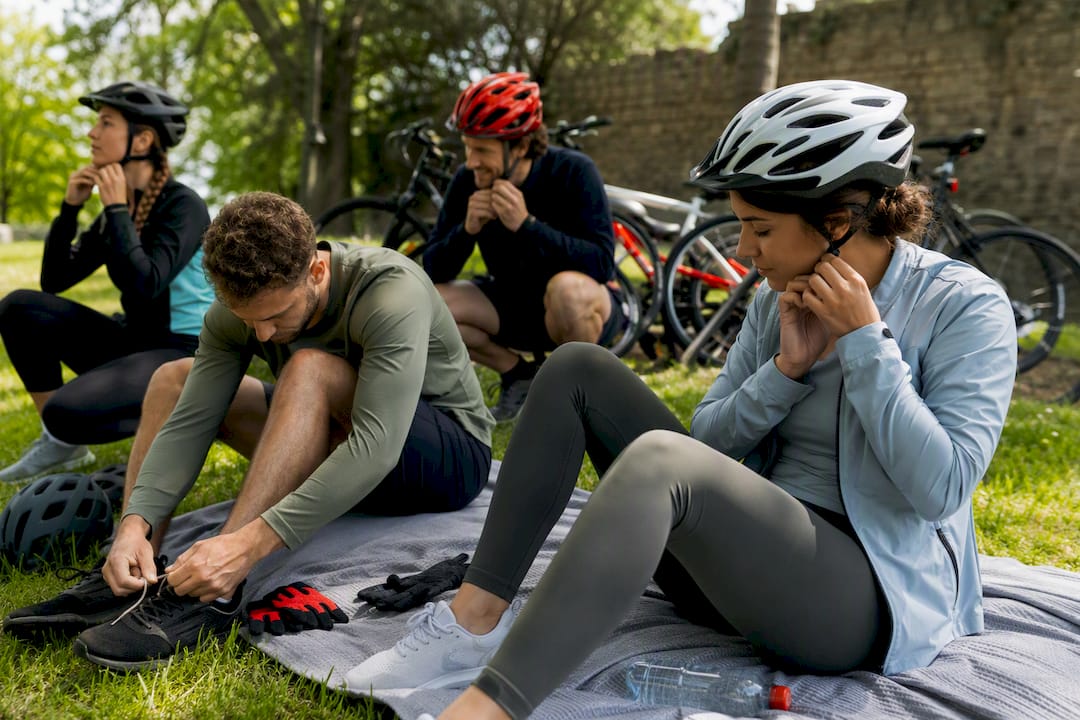 Hands adjusting helmets and shoes outdoors