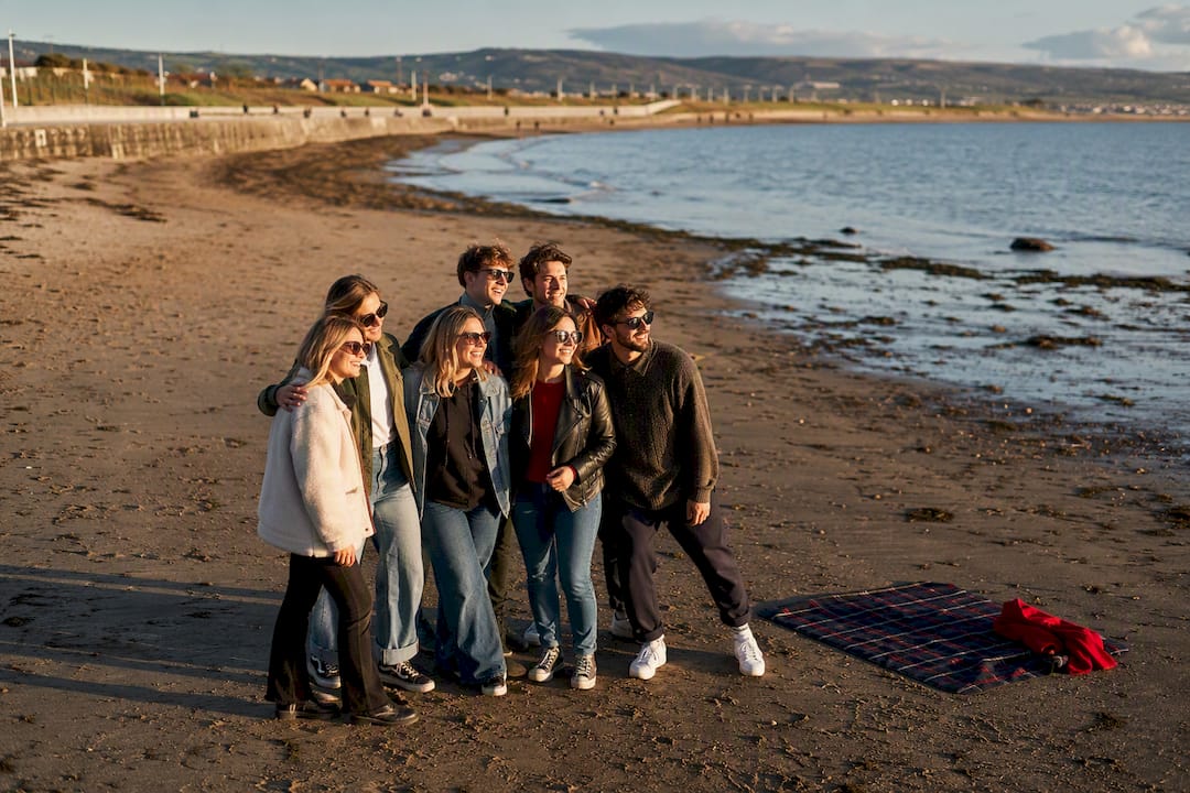 Friends photographing Galway beach shoreline