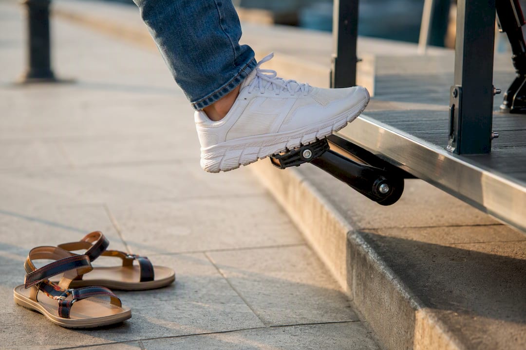 Closed-toe sneakers on party bike platform