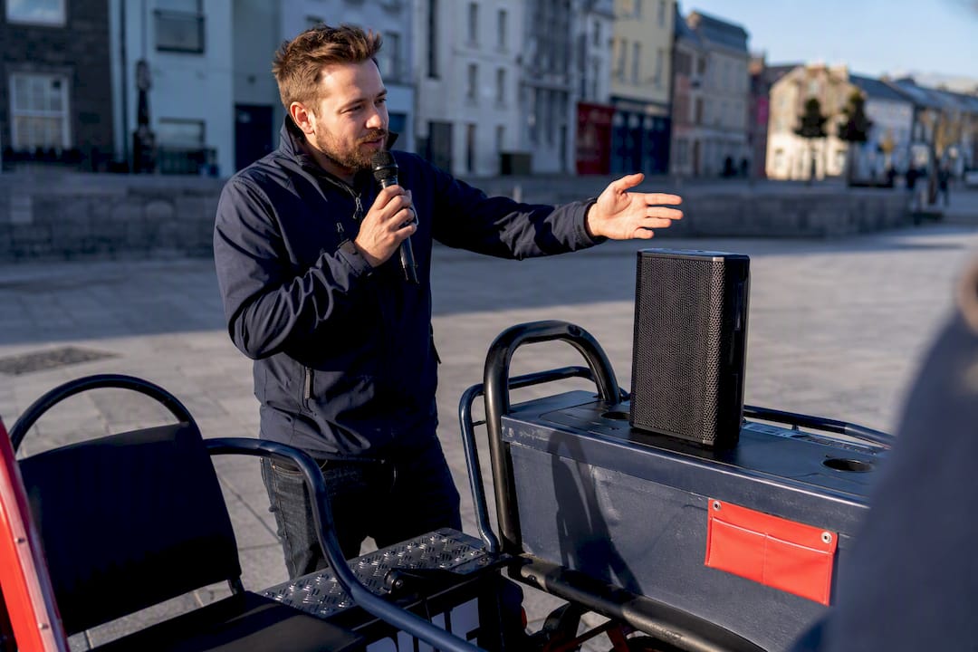 Quiz host testing sound outdoors in Galway