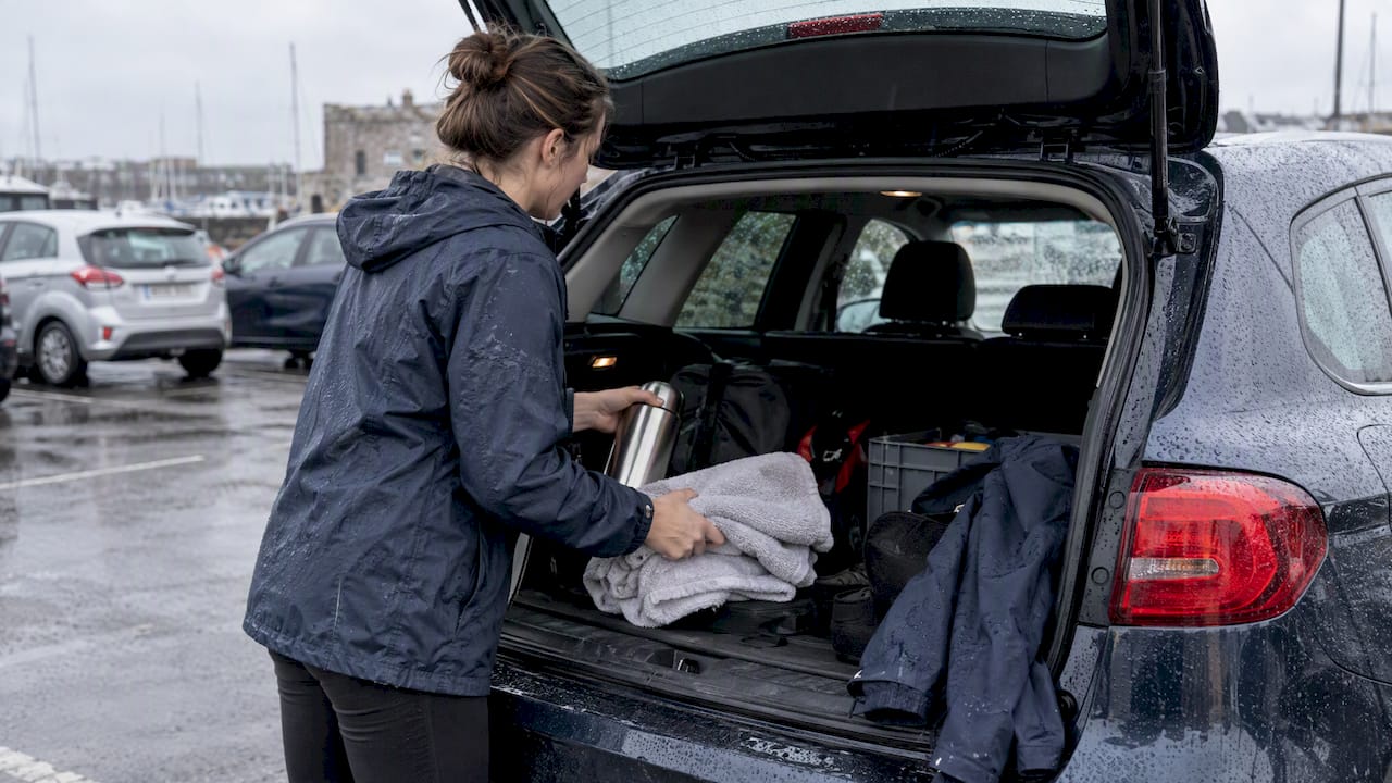 Flask towels and waterproof jacket in car boot
